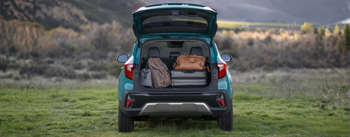Luggage in the trunk of a blue 2024 Kia Seltos