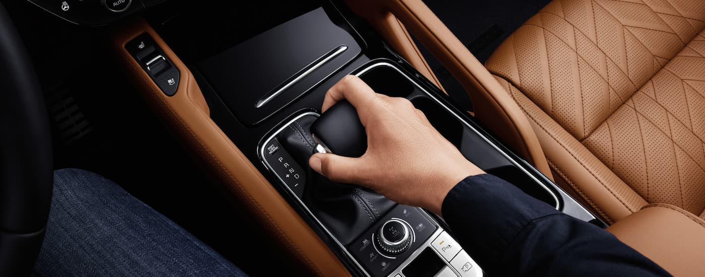 A person using the shifter in a 2025 Kia Telluride X-Pro for sale.