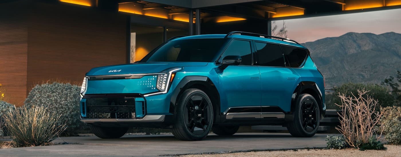 A blue 2024 Kia EV9 parked after visiting a Kia dealer near Milwaukee.