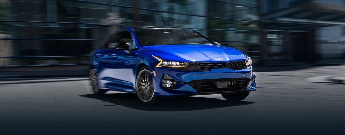 A blue 2025 Kia K5 parked for sale